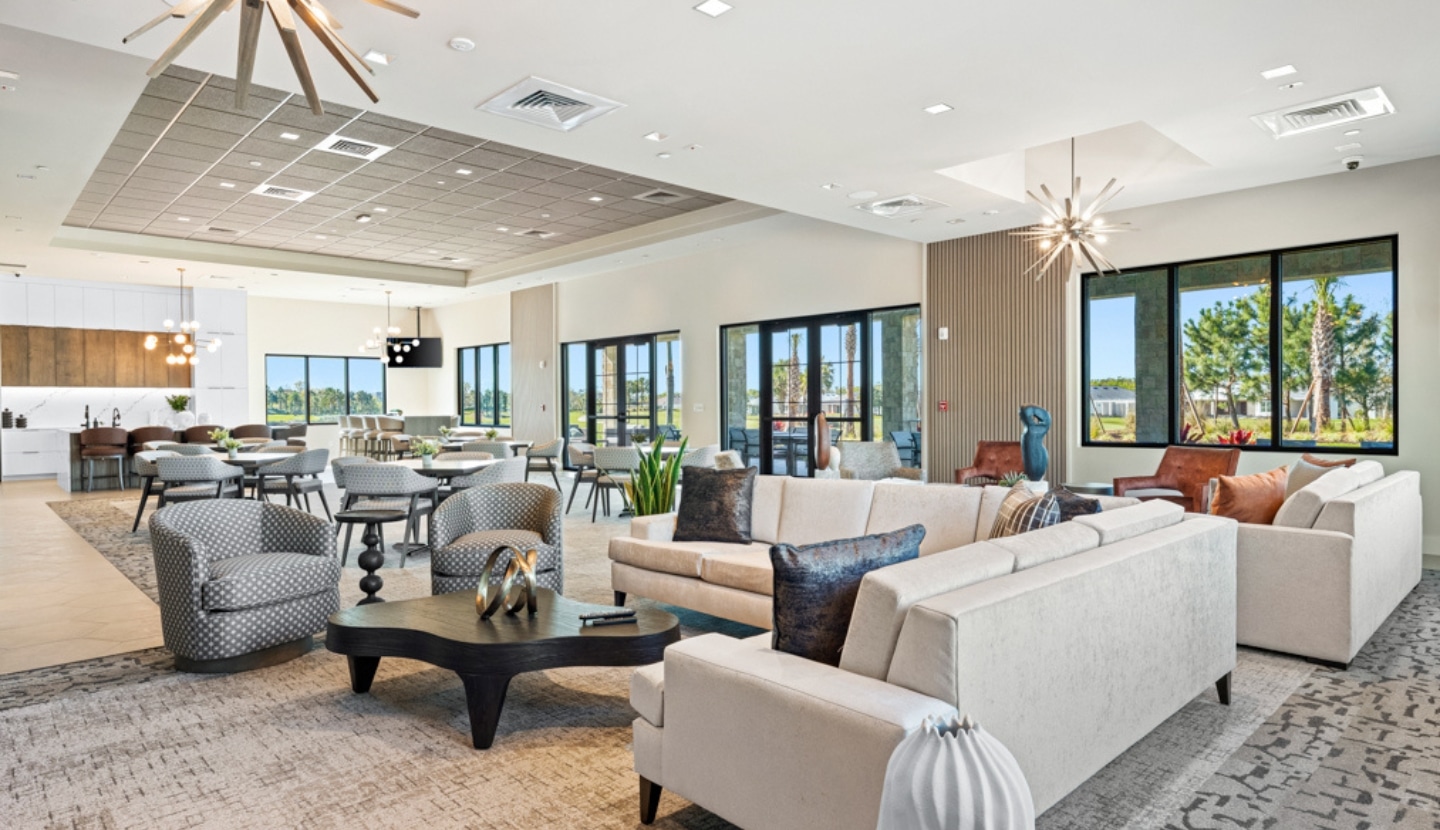 The lounge inside The Venue at Esplanade — sofas, gathering tables and floor-to-ceiling windows